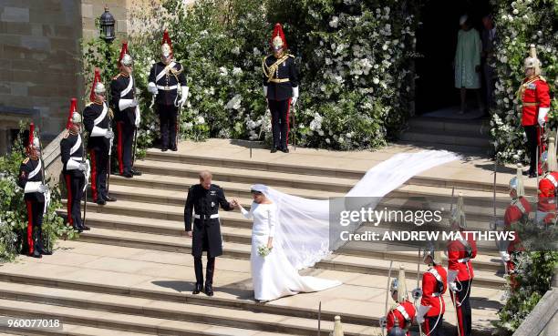 Britain's Prince Harry, Duke of Sussex and his wife Meghan, Duchess of Sussex emerge from the West Door of St George's Chapel, Windsor Castle, in...
