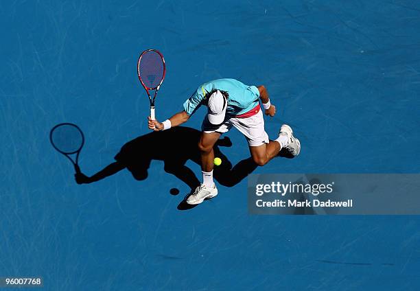 Denis Istomin of Uzbekistan plays a shot through his legs in his third round match against Novak Djokovic of Serbia during day six of the 2010...