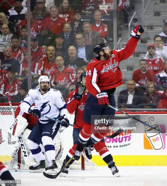 Brooks Orpik of the Washington Capitals reaches for the puck during the game against the Tampa Bay Lightning in Game Four of the Eastern Conference...