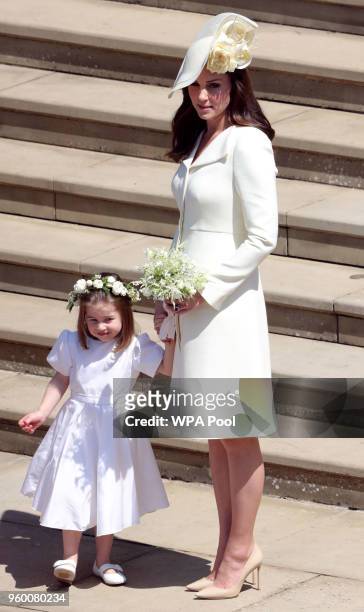 Catherine, Duchess of Cambridge and Princess Charlotte leave St George's Chapel, Windsor Castle after the wedding of Prince Harry, Duke of Sussex and...