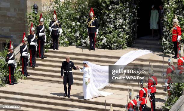 Prince Harry, Duke of Sussex and The Duchess of Sussex leave St George's Chapel, Windsor Castle after their wedding ceremony on May 19, 2018 in...