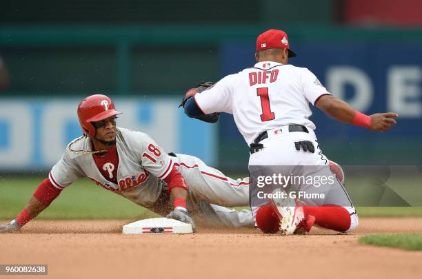 Pedro Florimon of the Philadelphia Phillies steals second base under the tag of Wilmer Difo of the Washington Nationals at Nationals Park on May 6,...
