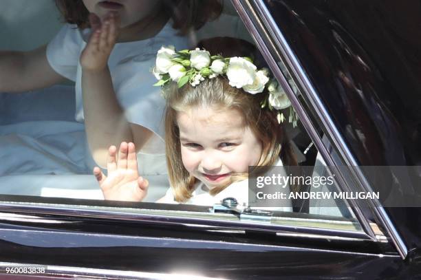 Prince Harry's niece and bridesmaid Princess Charlotte waves as she arrives for the wedding ceremony of Britain's Prince Harry, Duke of Sussex and US...