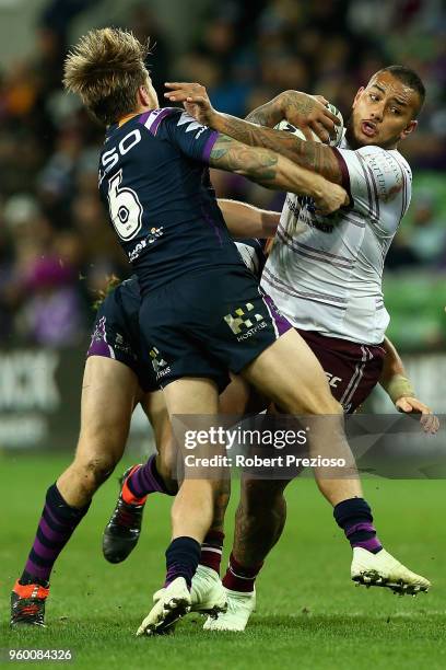 Addin Fonua-Blake of the Manly Sea Eagles is tackled during the round 11 NRL match between the Melbourne Storm and the Manly Sea Eagles at AAMI Park...