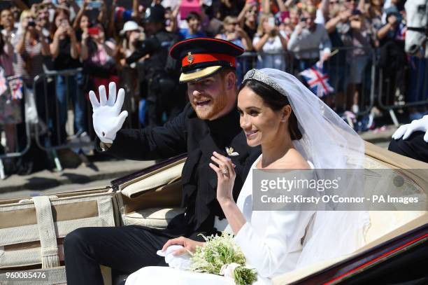 Prince Harry and Meghan Markle ride in an Ascot Landau past Victoria Barracks in Windsor after their wedding in St George's Chapel.