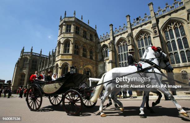 Prince Harry and Meghan Markle ride in an Ascot Landau after their wedding ceremony to Prince Harry at St. George's Chapel in Windsor Castle.