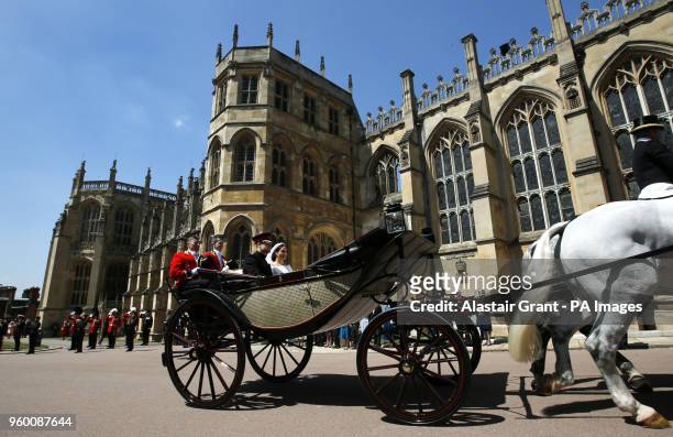 Prince Harry and Meghan Markle ride in an Ascot Landau after their wedding ceremony to Prince Harry at St. George's Chapel in Windsor Castle.