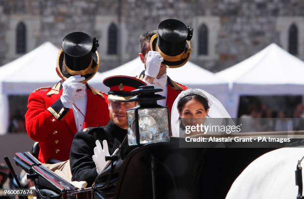 Prince Harry and Meghan Markle ride in an Ascot Landau after their wedding ceremony to Prince Harry at St. George's Chapel in Windsor Castle.