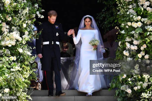 Britain's Prince Harry, Duke of Sussex and his wife Meghan, Duchess of Sussex leave from the West Door of St George's Chapel, Windsor Castle, in...