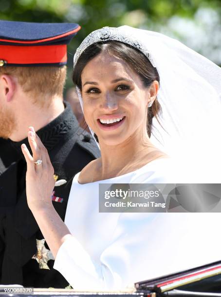 Meghan, Duchess of Sussex leaves Windsor Castle in the Ascot Landau carriage during a procession after getting married at St Georges Chapel on May...