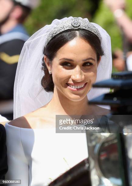 Meghan, Duchess of Sussex leaves Windsor Castle in the Ascot Landau carriage during a procession after getting married at St Georges Chapel on May...