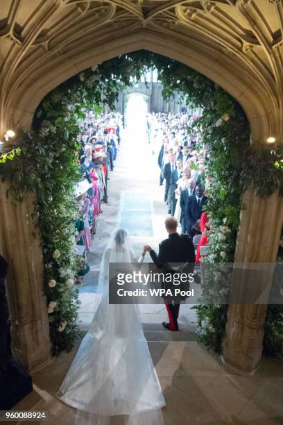 Britain's Prince Harry, Duke of Sussex and his wife the Duchess of Sussex leave from St George's Chapel, Windsor Castle, in Windsor on May 19, 2018...