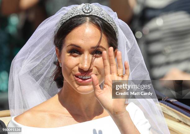 The Duchess of Sussex waves from the Ascot Landau carriage during the procession after their marriage St George's Chapel on May 19, 2018 in Windsor,...