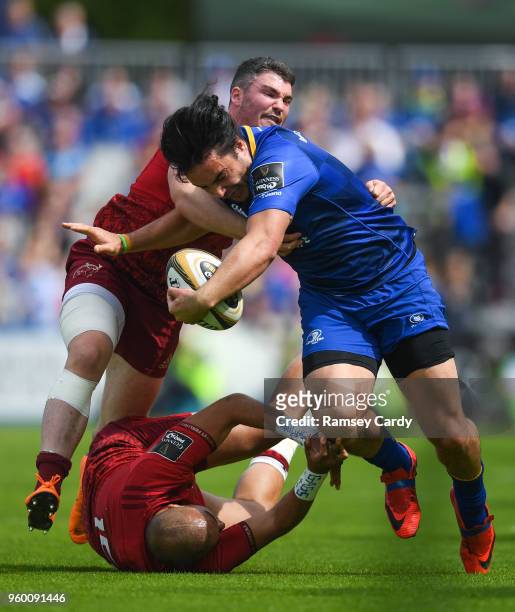 Dublin , Ireland - 19 May 2018; James Lowe of Leinster is tackled by Simon Zebo, below, and Sammy Arnold of Munster during the Guinness PRO14...