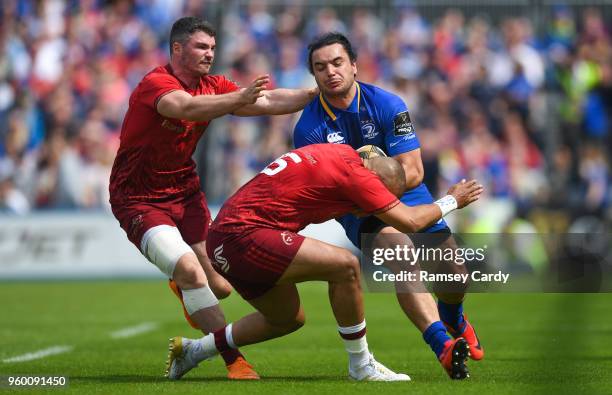 Dublin , Ireland - 19 May 2018; James Lowe of Leinster is tackled by Simon Zebo, right, and Sammy Arnold of Munster during the Guinness PRO14...