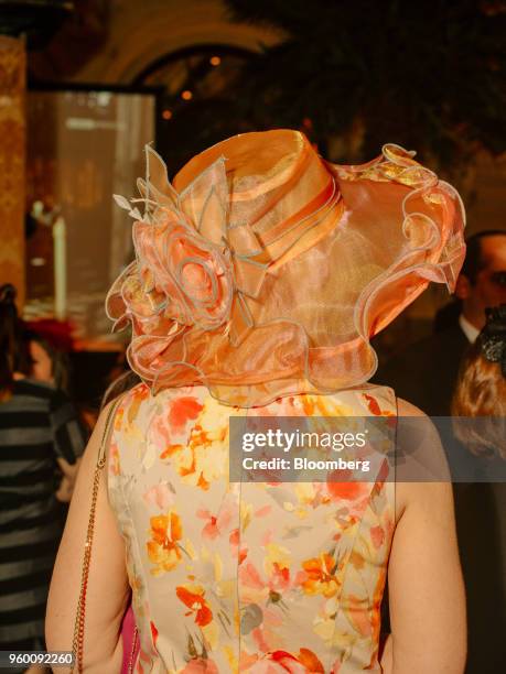 An attendee wears a floral dress and decorative hat during a royal wedding viewing party at the Plaza Hotel in New York, U.S., on Saturday, May 19,...