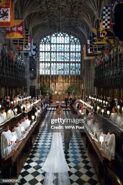 Meghan Markle walks up the aisle with the Prince Charles, Prince of Wales at St George's Chapel at Windsor Castle during her wedding to Prince Harry...