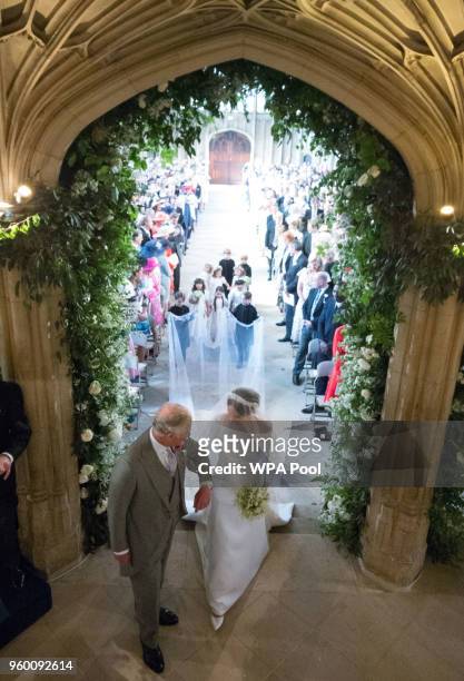 Meghan Markle walks up the aisle with the Prince Charles, Prince of Wales at St George's Chapel at Windsor Castle during her wedding to Prince Harry...