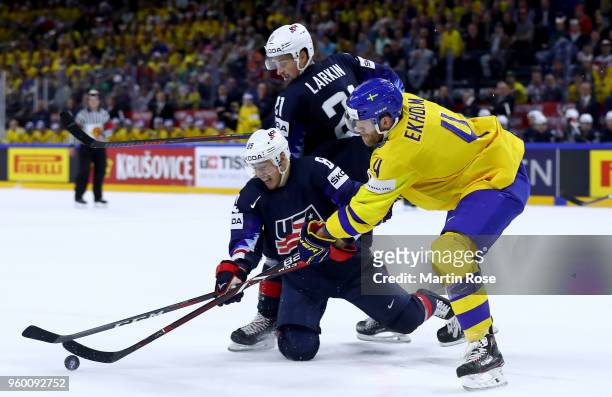 Mattias Ekhol of Sweden and Cam Atkinson of the United States battle for the puck during the 2018 IIHF Ice Hockey World Championship Semi Final game...