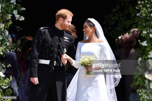 Britain's Prince Harry, Duke of Sussex and his wife Meghan, Duchess of Sussex leave from the West Door of St George's Chapel, Windsor Castle, in...