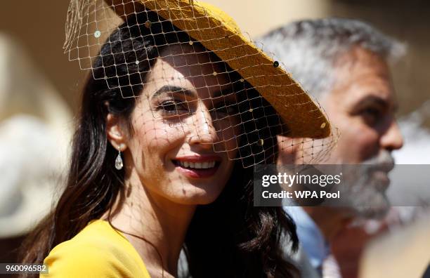 Amal Clooney and George Clooney arrive at St George's Chapel at Windsor Castle for the wedding of Prince Harry and Meghan Markle on May 19, 2018 in...