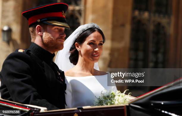 Prince Harry, Duke of Sussex and The Duchess of Sussex leave Windsor Castle in the Ascot Landau carriage during a procession after getting married at...