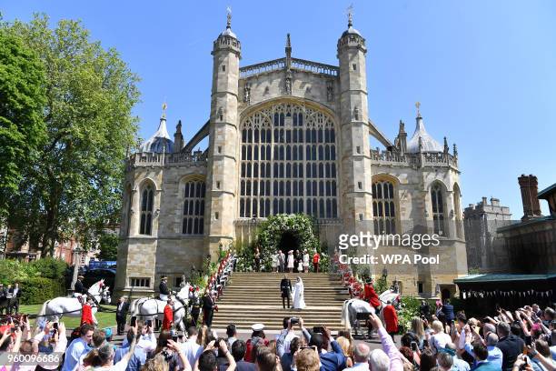 Britain's Prince Harry, Duke of Sussex and his wife Meghan, Duchess of Sussex leave from the West Door of St George's Chapel, Windsor Castle, in...