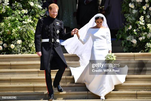 Prince Harry, Duke of Sussex and his wife Meghan, Duchess of Sussex leave from the West Door of St George's Chapel, Windsor Castle, in Windsor on May...