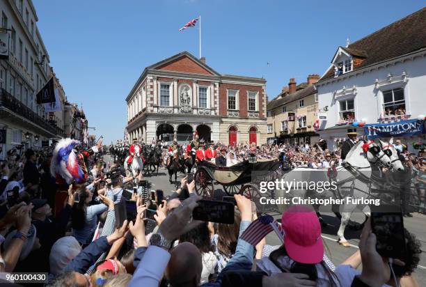 Prince Harry, Duke of Sussex and Meghan, Duchess of Sussex leave Windsor Castle in the Ascot Landau carriage during a procession after getting...