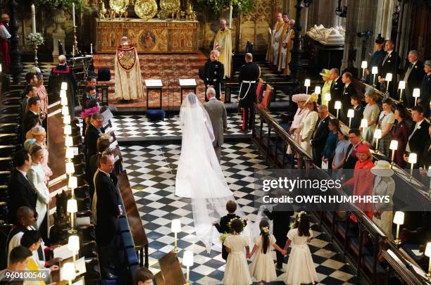 Actress Meghan Markle , accompanied by Britain's Prince Charles, Prince of Wales walks down the aisle toward her husband-to-be Britain's Prince...