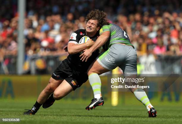 Alec Hepburn of Exeter Chiefs is tackled by Kyle Cooper of Newcastle Falcons during the Aviva Premiership Semi Final between Exeter Chiefs and...