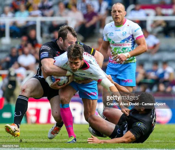St Helens' Louie McCarthy-Scarsbrook is tackled by Widnes Vikings's Hep Cahill and Greg Burke during the Betfred Super League Round 15 match between...