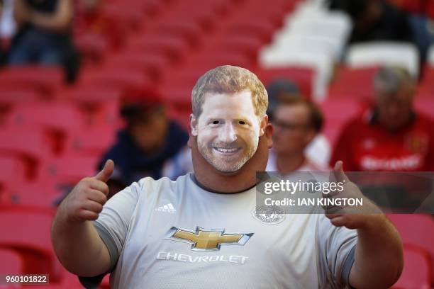 Manchester United fan wears a Prince Harry mask in the crowd ahead of the English FA Cup final football match between Chelsea and Manchester United...