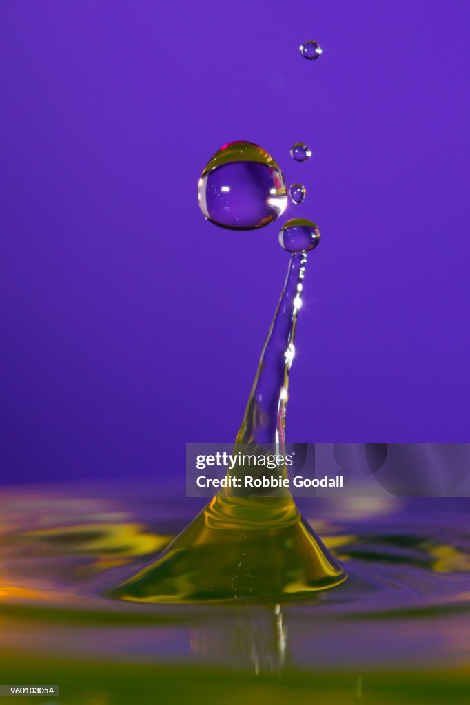 Water drip on a purple backdrop