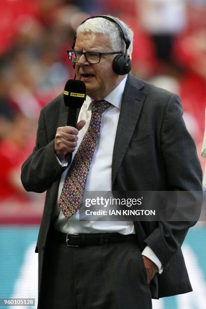 Commentator John Motson broadcasts pitch-side ahead of the English FA Cup final football match between Chelsea and Manchester United at Wembley...