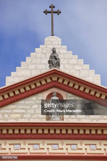 detail of santa barbara mission above the entrance with religious icons and crucifix - mission santa barbara stock pictures, royalty-free photos & images