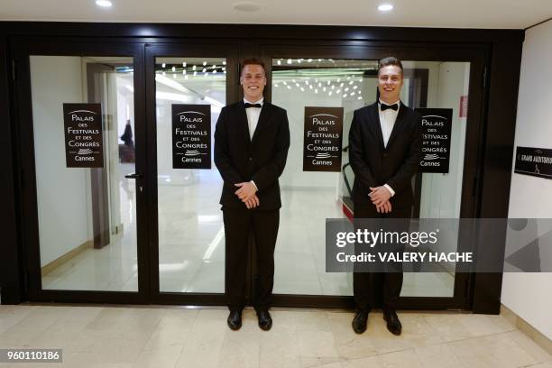 Staff members Matthieu and his twin brother Benjamin Verrier stand on May 19, 2018 outside the Auditorium Lumiere cinema at the Festival Palace...