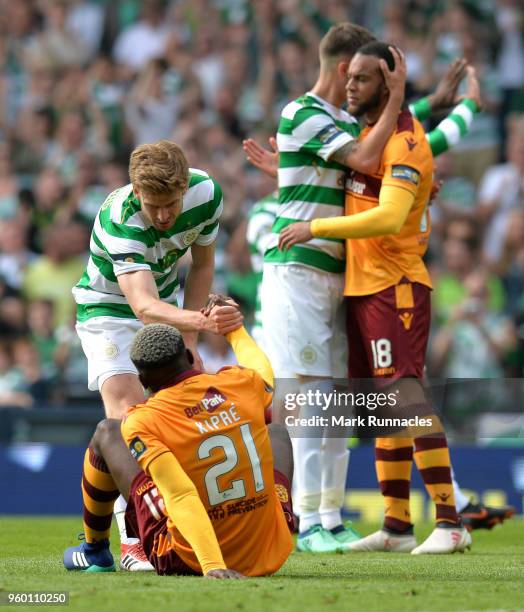 Stuart Armstrong of Celtic helps dejected Cedric Kipre of Motherwell following the Scottish Cup Final between Motherwell and Celtic at Hampden Park...