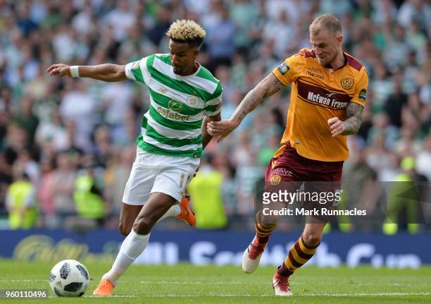 Scott Sinclair of Celtic runs with the ball under pressure from Richard Tait of Motherwell during the Scottish Cup Final between Motherwell and...