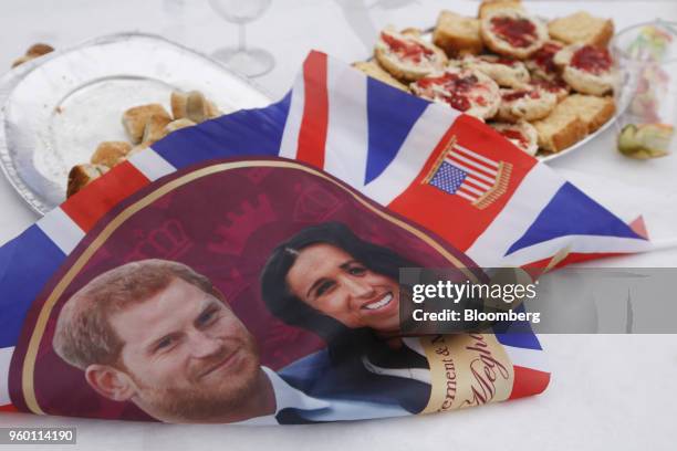 Flag displays an image of Prince Harry and Meghan Markle, who will become the Duchess of Sussex, next to scones during a street party to celebrate...