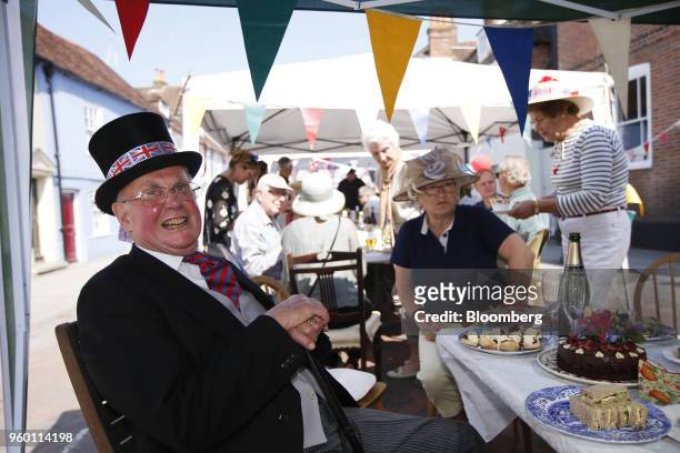 An attendee wears a top hat decorated with Union flags, also known as Union Jacks, during a street party to celebrate the wedding of Britain's Prince...