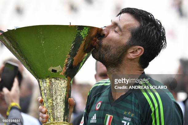 Juventus' goalkeeper from Italy Gianluigi Buffon kisses the trophy during the victory ceremony following the Italian Serie A last football match of...