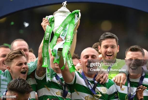 Scott Brown of Celtic lifts the Scottish Cup Trophy following his side's win at the Scottish Cup Final between Motherwell and Celtic at Hampden Park...