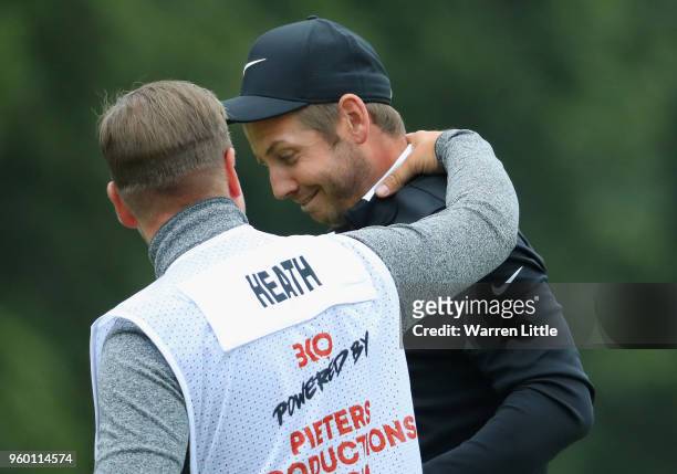 James Heath of England is congratulated by his caddie after beating Robert Karlsson of Sweden during the knockout stage on day three of the Belgian...