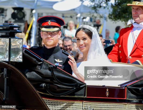 Prince Harry, Duke of Sussex and Meghan, Duchess of Sussex leave Windsor Castle in the Ascot Landau carriage during a procession after getting...