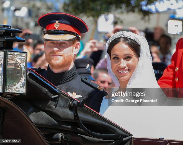 Prince Harry, Duke of Sussex and Meghan, Duchess of Sussex leave Windsor Castle in the Ascot Landau carriage during a procession after getting...
