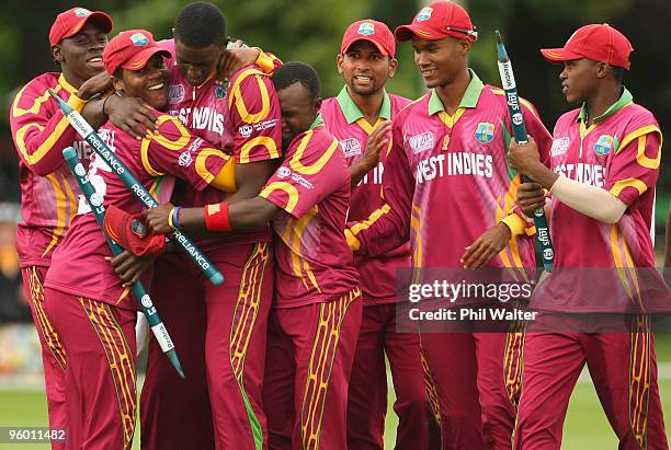 Jason Holder of the West Indies is hugged by John Campbell as he celebrates his wicket of David Payne of England to win the match during the ICC U19...