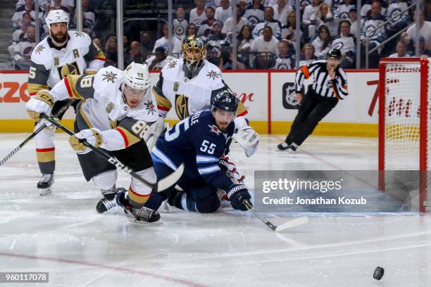 Deryk Engelland, Nate Schmidt, goaltender Marc-Andre Fleury of the Vegas Golden Knights and Mark Scheifele of the Winnipeg Jets eye the loose puck...