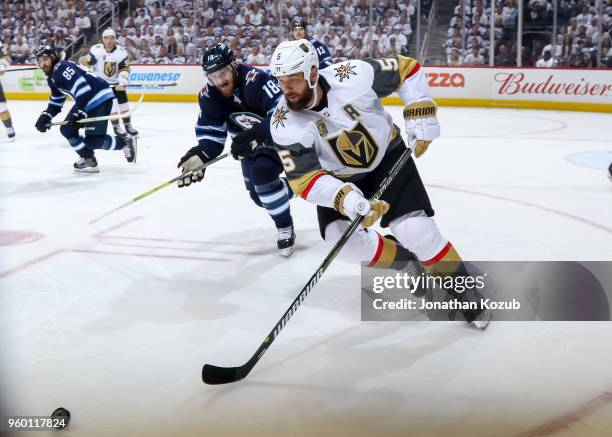 Deryk Engelland of the Vegas Golden Knights plays the puck as Bryan Little of the Winnipeg Jets gives chase during third period action in Game Two of...