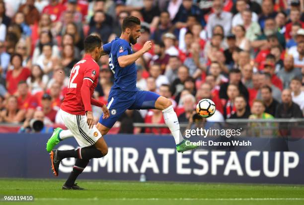 Olivier Giroud of Chelsea controls the ball under pressure from Chris Smalling of Manchester United during The Emirates FA Cup Final between Chelsea...